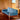 Elegant Teak Three-Seat Sofa with Olive Green Striped Cushions